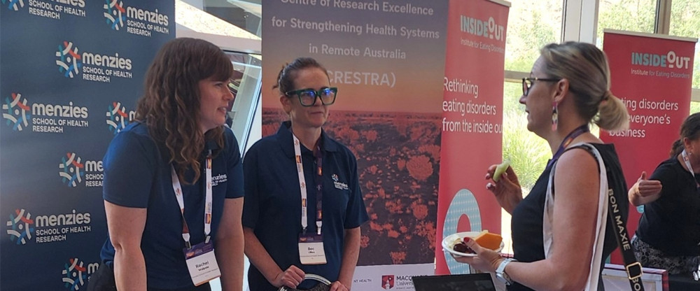 People talking at a trade booth