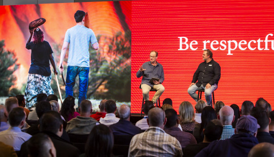 two speakers on stage at plenary for conference in Uluru