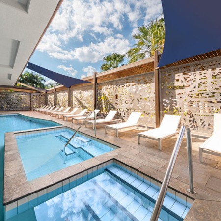 Pool and lounge chairs at Adina Apartment Hotel 