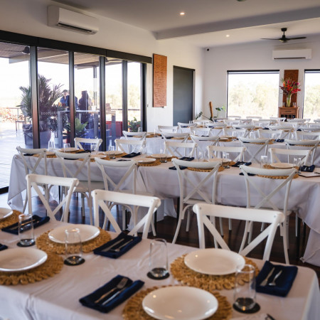 Set dining tables inside Finniss River Lodge restaurant prepared for guests.
