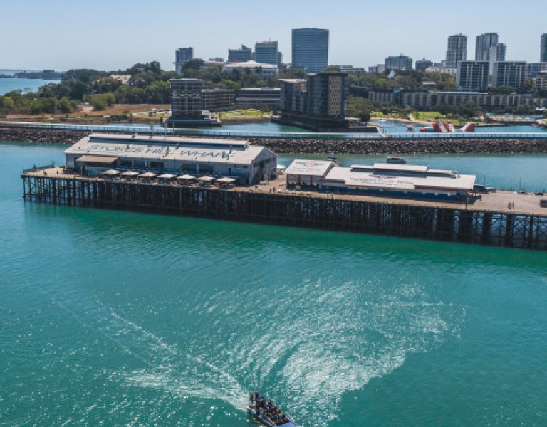 Ariel view of airboat on Darwin Harbour with Stokes Hill Wharf in the background