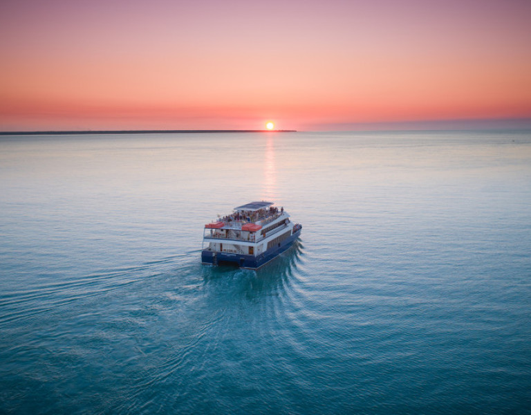 Ariel view of boat on the ocean at sunset 