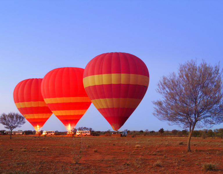 row of red balloons in the outback