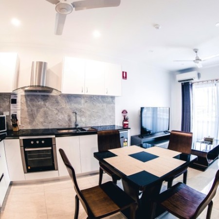 Living area and kitchen in hotel room 