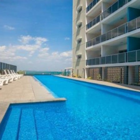 Pool and lounge chairs at Ramada Zan
