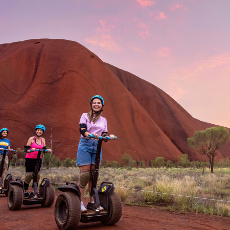 People riding Segways around base of Uluru