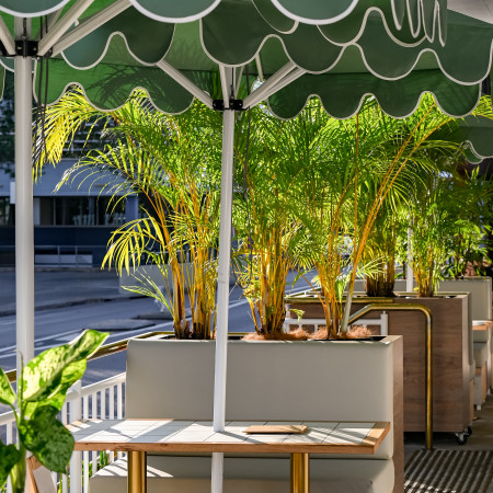 booth outdoor dining area surrounded by greenery