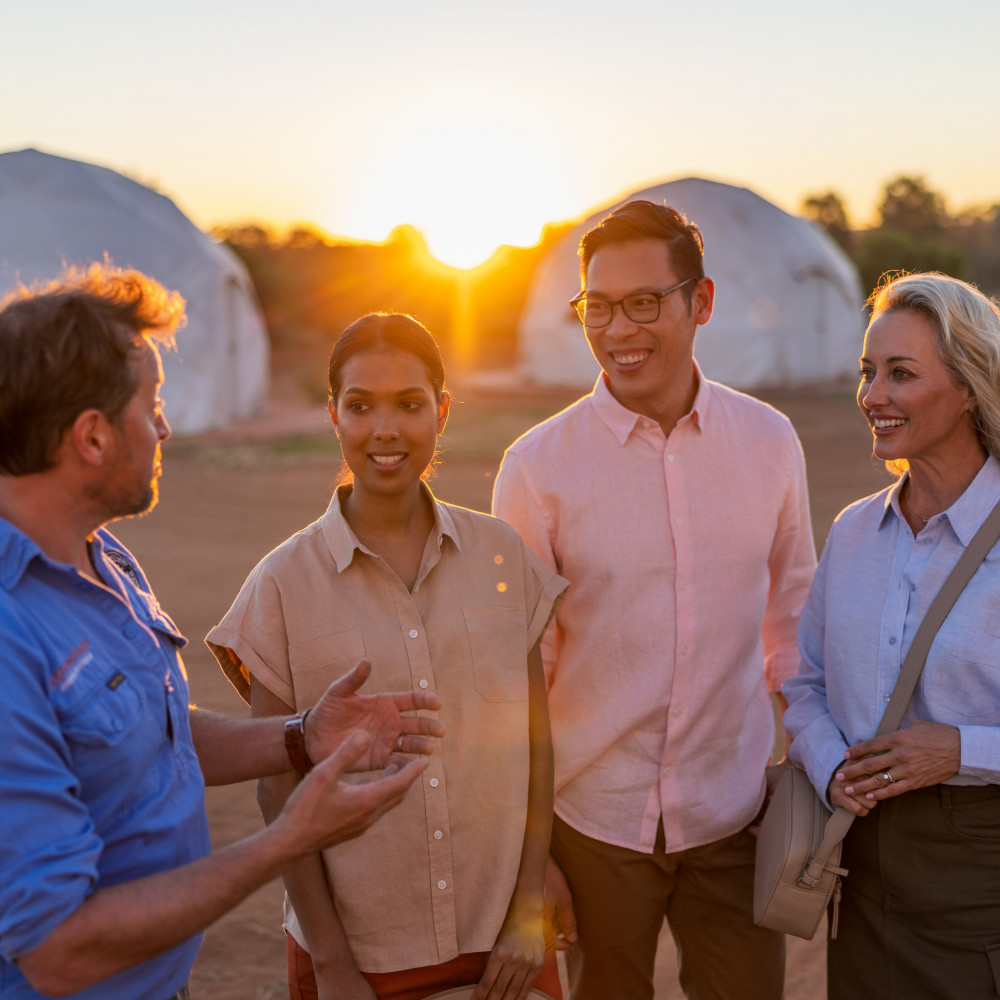 Group of people talking in front of Earth Sanctuary 